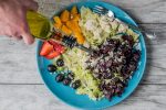 flat lay photography of man making vegetable and fruit salad