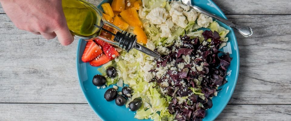flat lay photography of man making vegetable and fruit salad